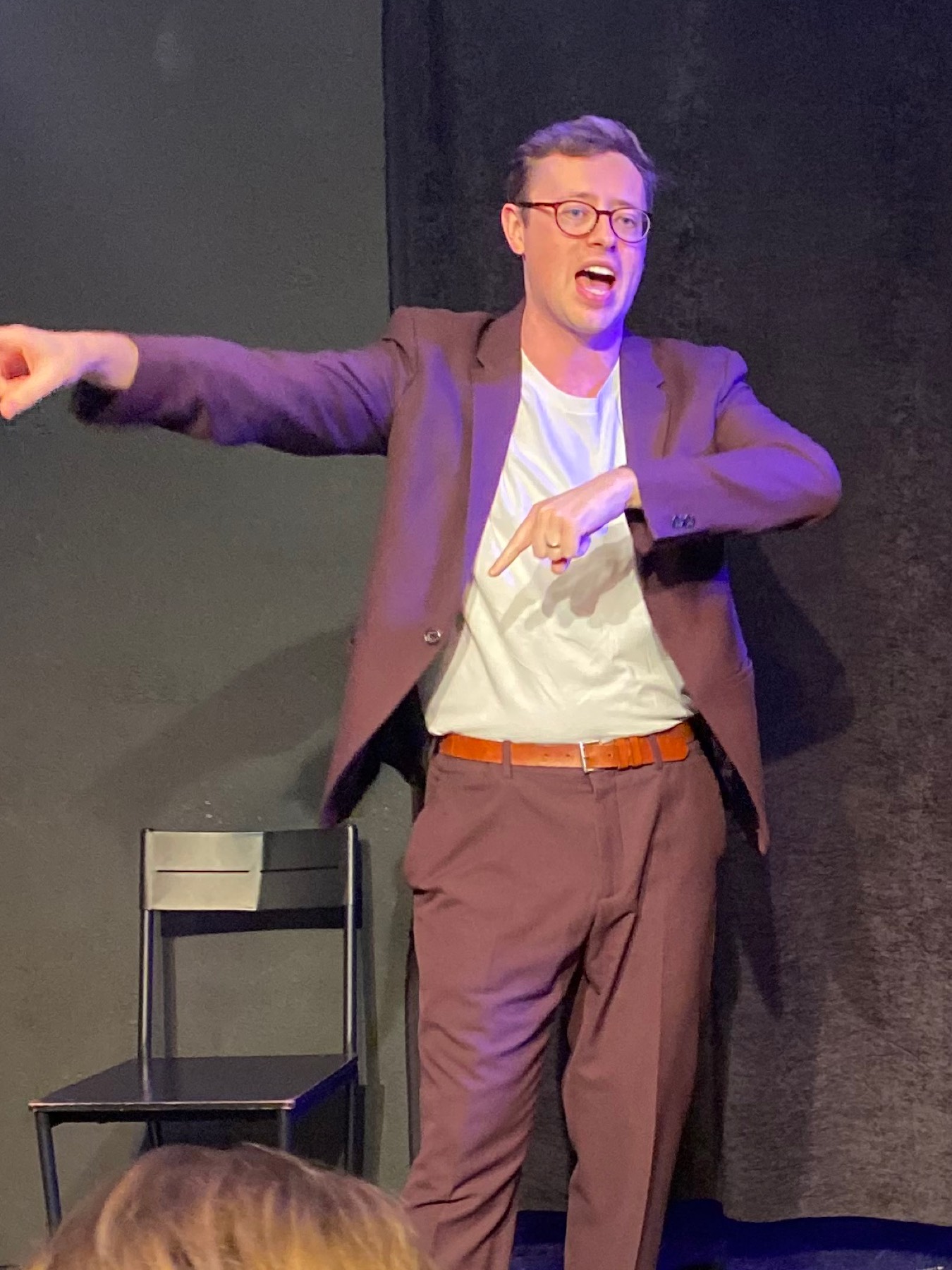 Dan performing walkaround magic, guests leaning in